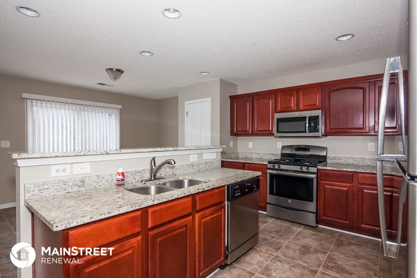 a kitchen with stainless steel appliances and granite counter tops