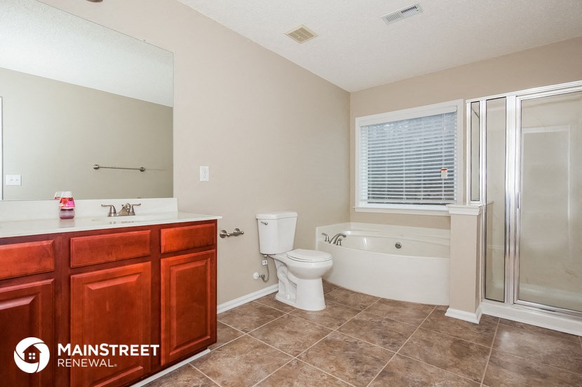 a bathroom with a toilet sink and tub and a shower