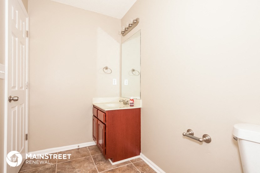 a bathroom with a sink and a mirror and a toilet