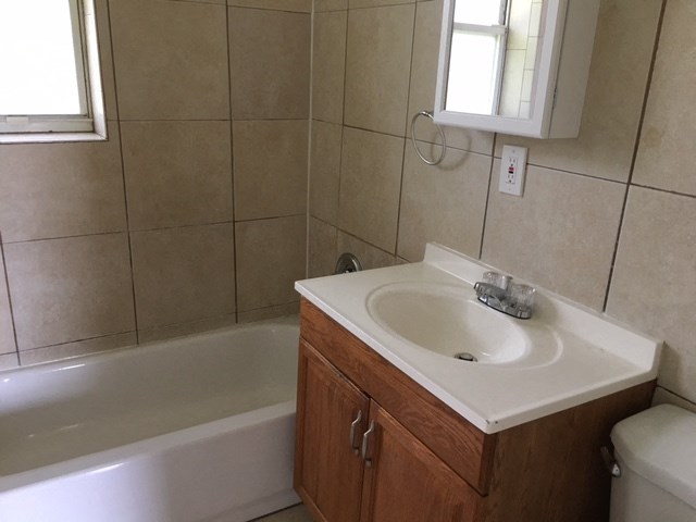 a bathroom with a sink and a bath tub