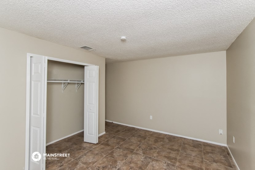 a bedroom with a closet and a door to a walk in closet