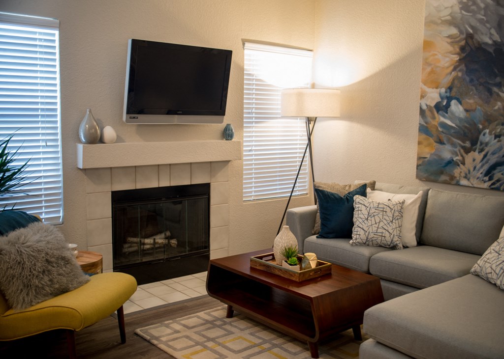 a living room with a fireplace and a television