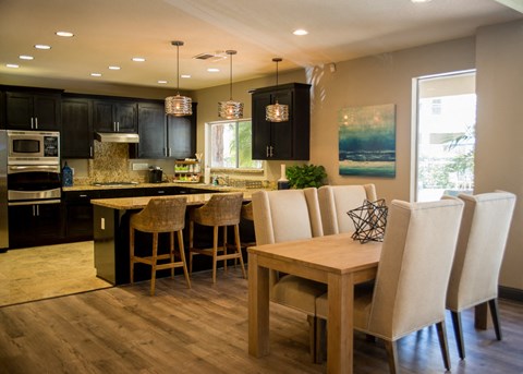 a kitchen and dining room with a table and chairs