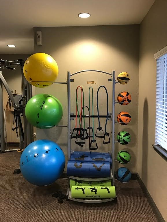 a gym with weights and other equipment in a room