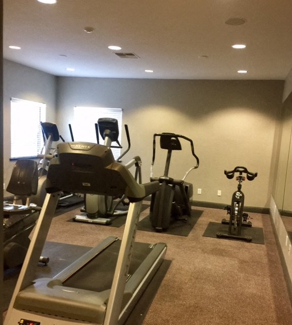 a gym with a lot of machines in it