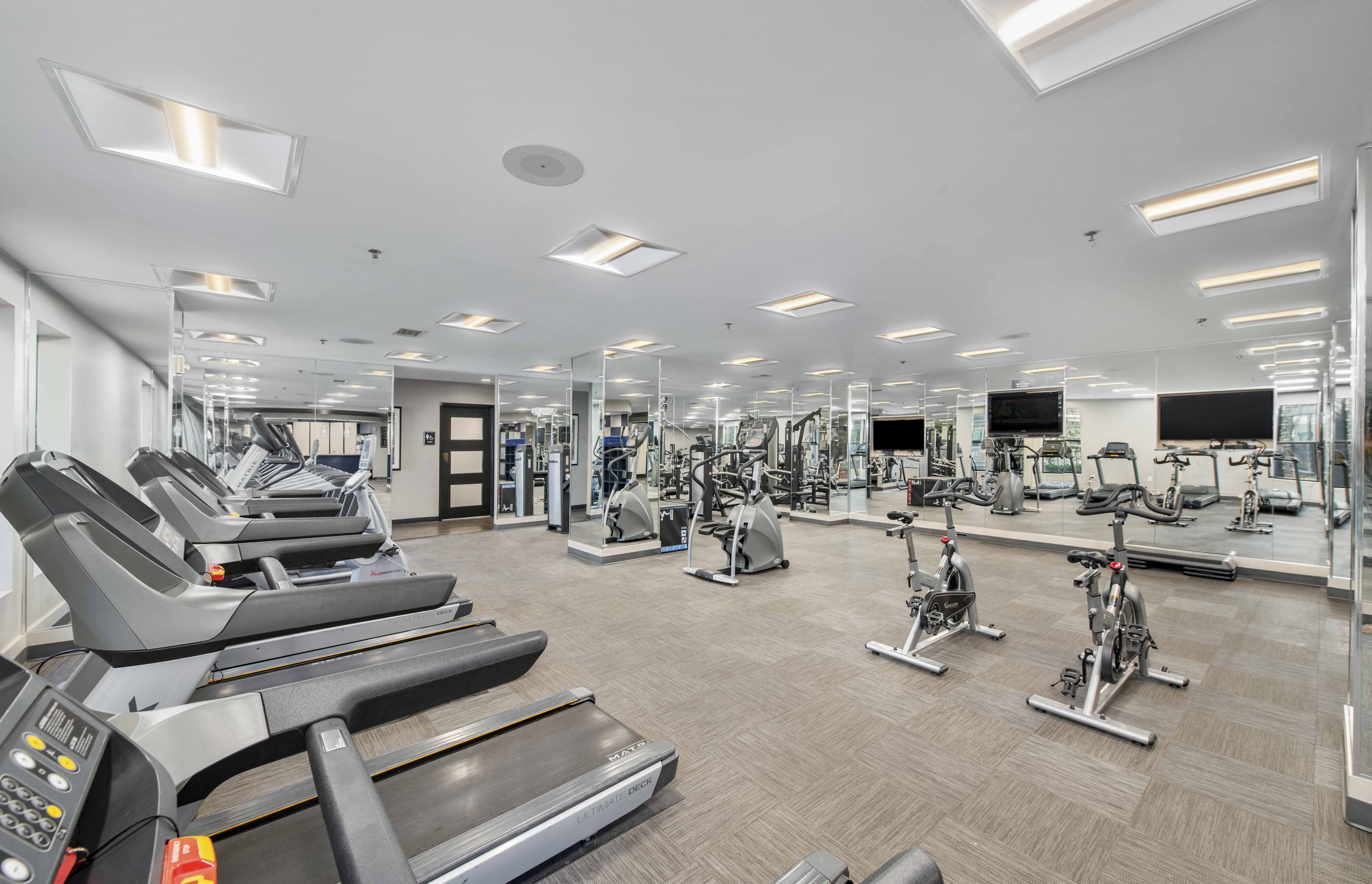 a gym with treadmills and other exercise equipment