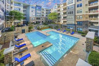 a swimming pool at an apartment building with an empty pool
