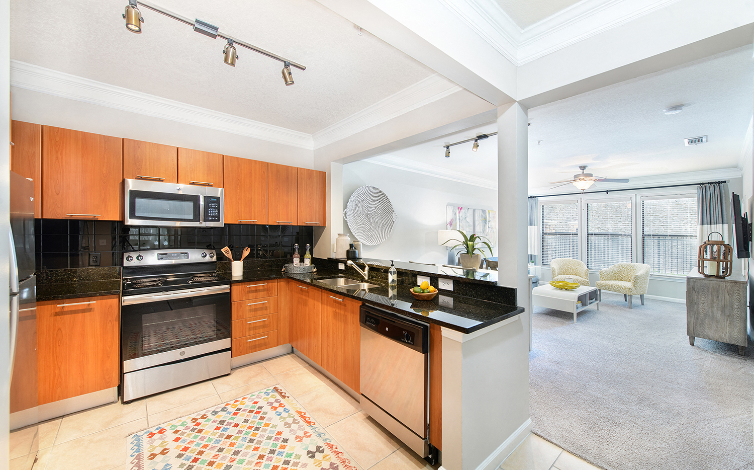a kitchen with wooden cabinets and stainless steel appliances