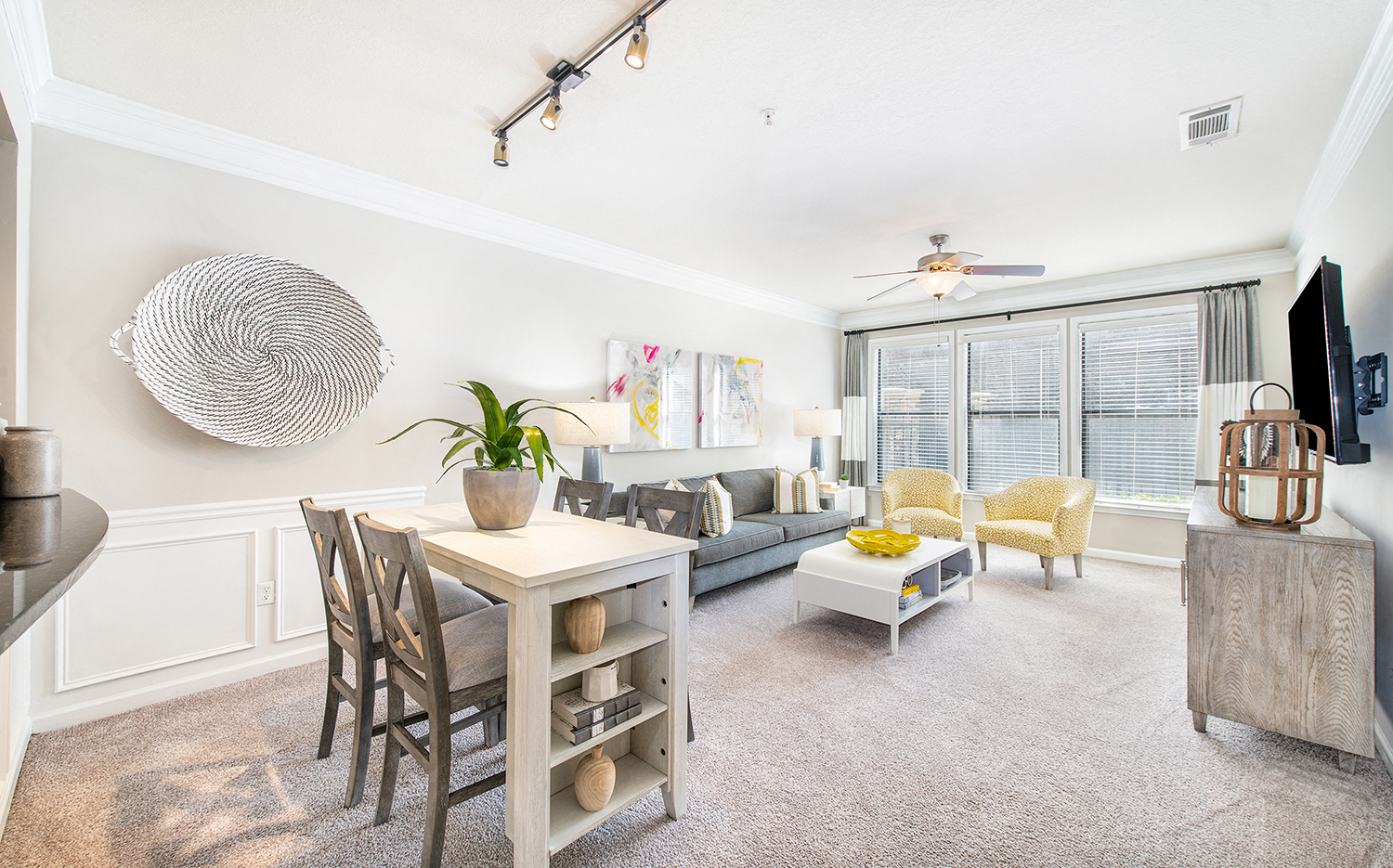 a living room with a dining room table and a couch