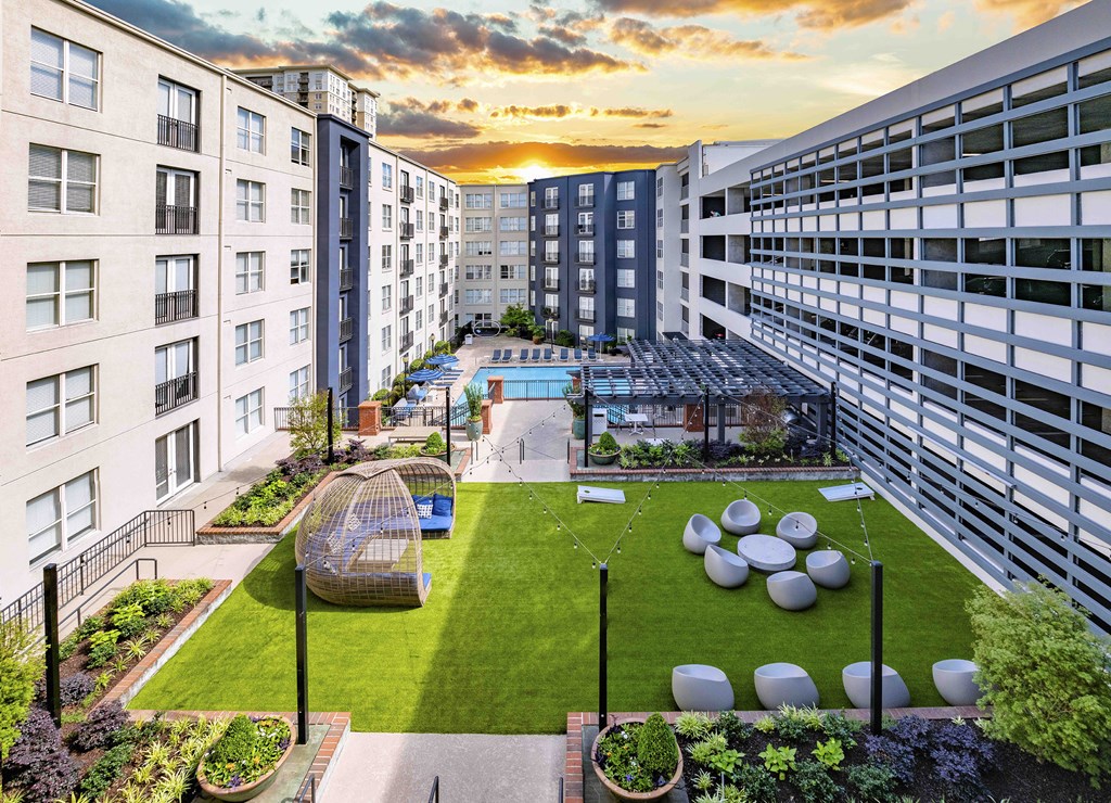 an aerial view of the courtyard of an apartment building at sunset