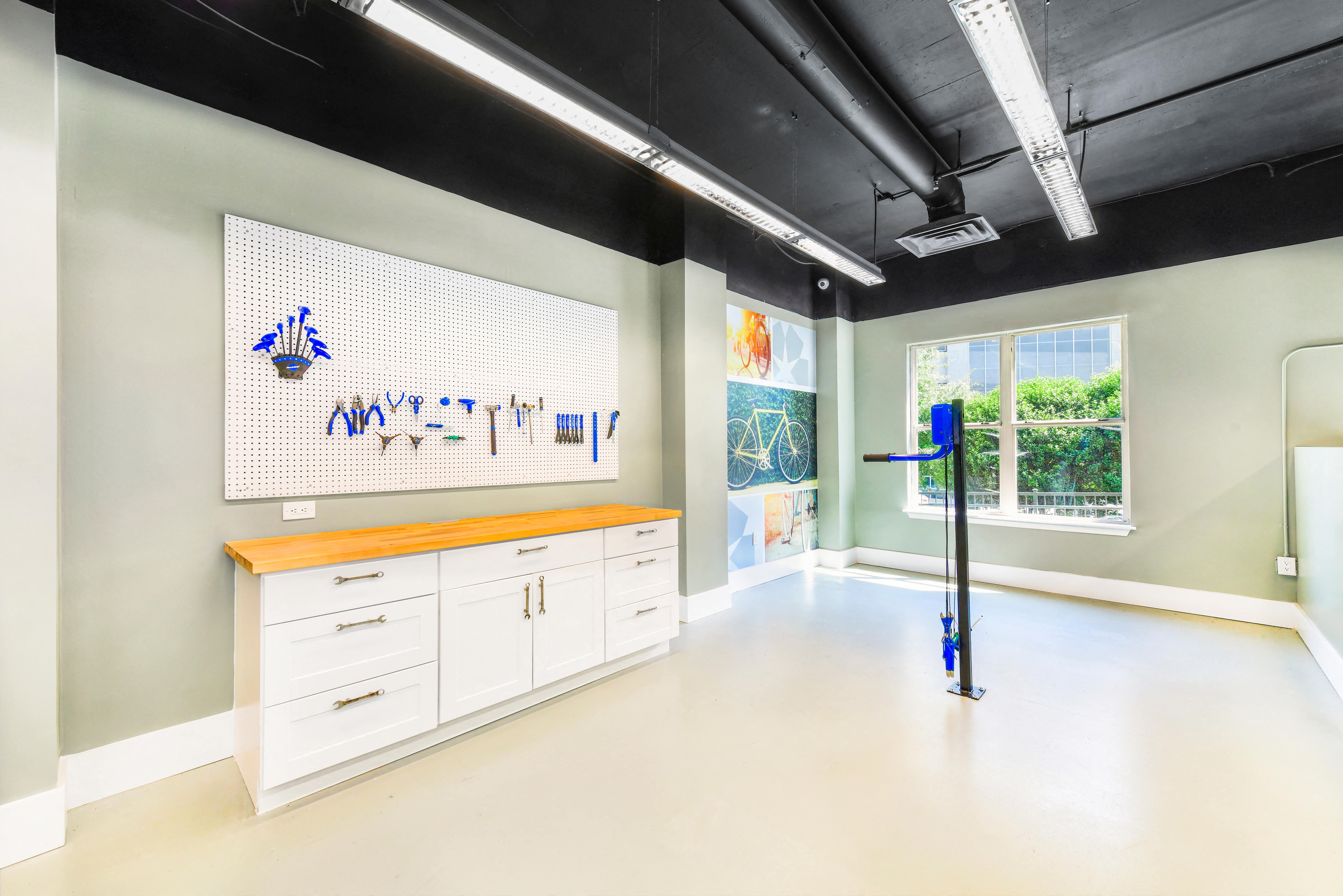 a room with white cabinets and a large painting on the wall