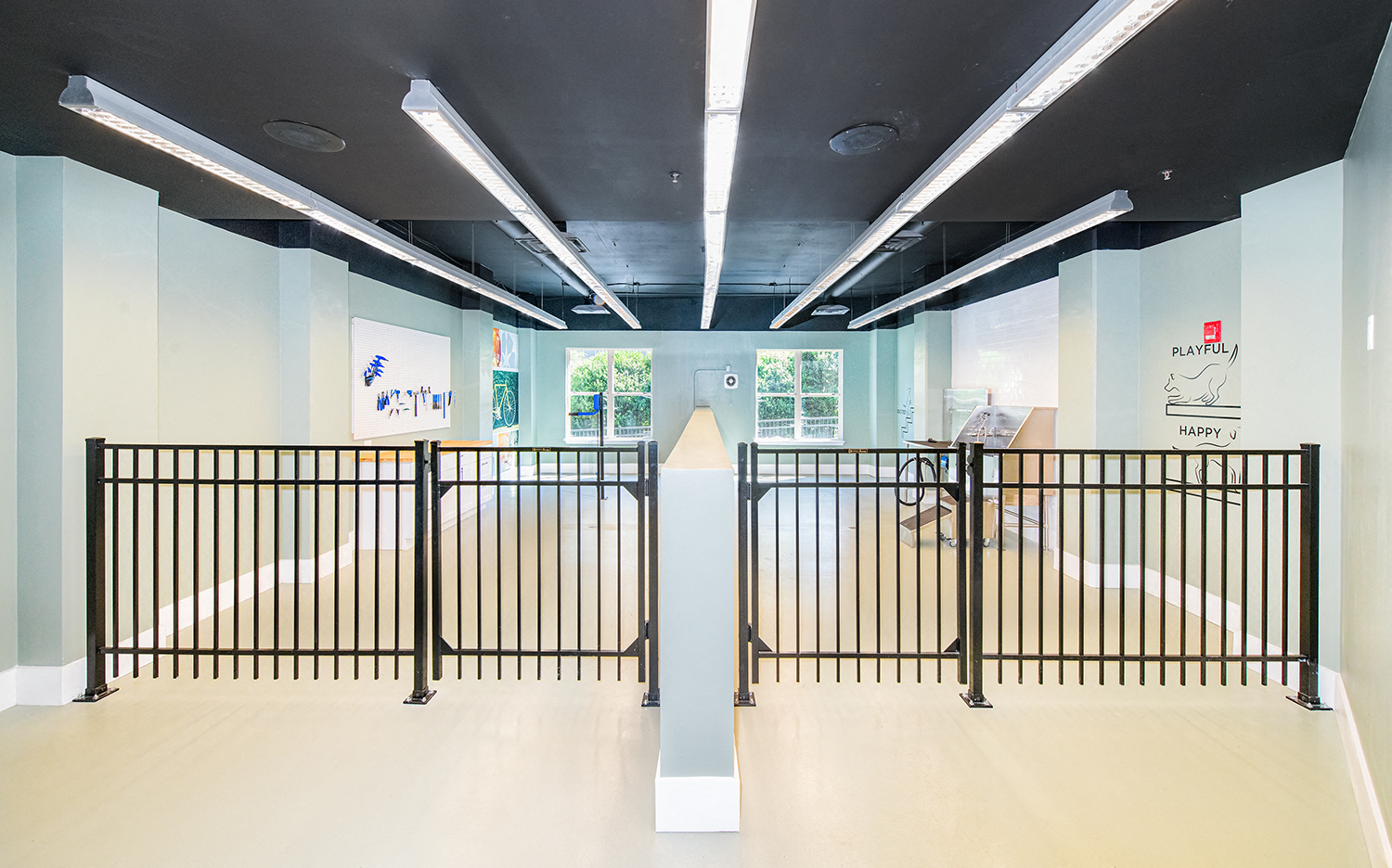 a fenced in area in a room with a wheelchair ramp