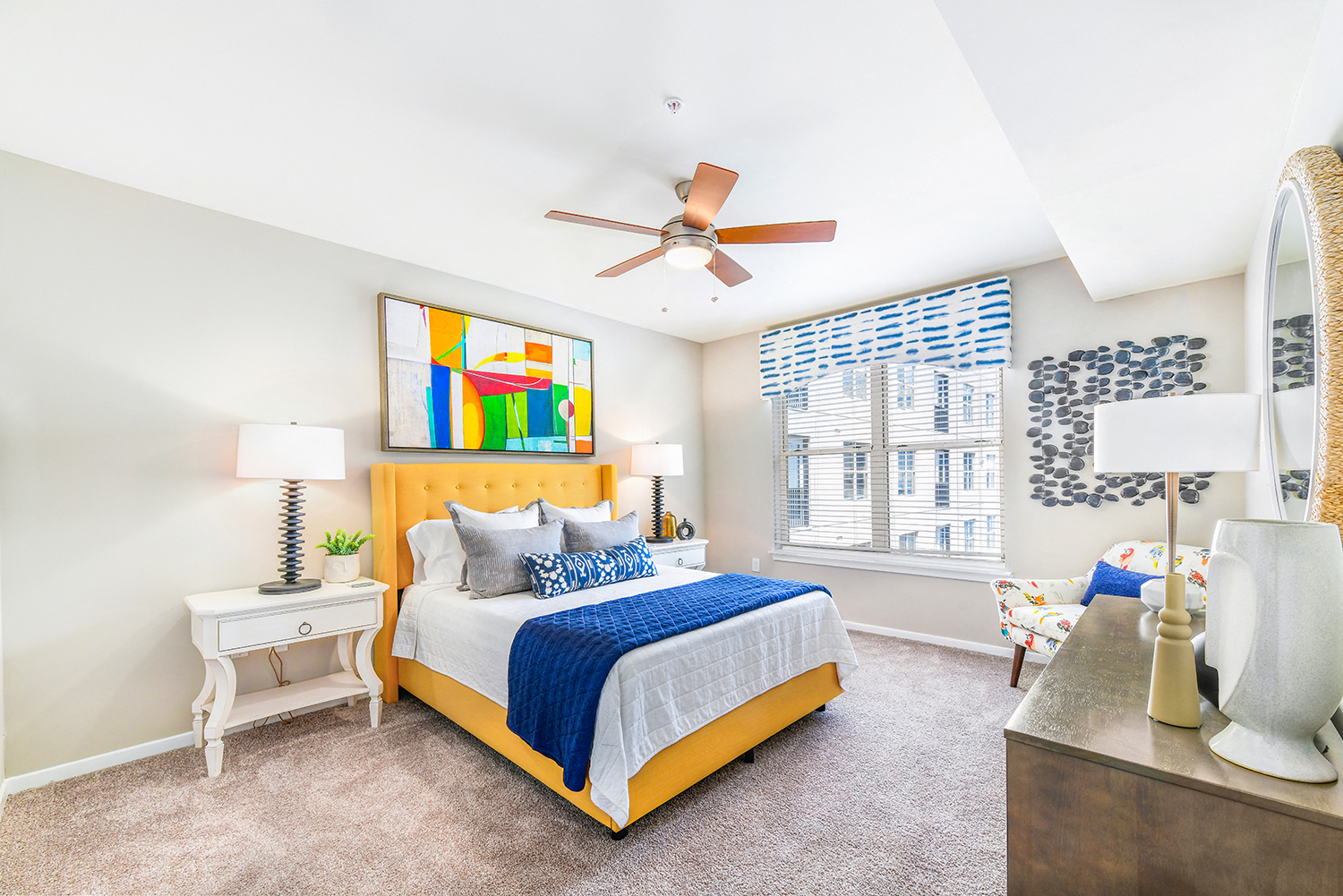 a bedroom with a yellow bed and a ceiling fan