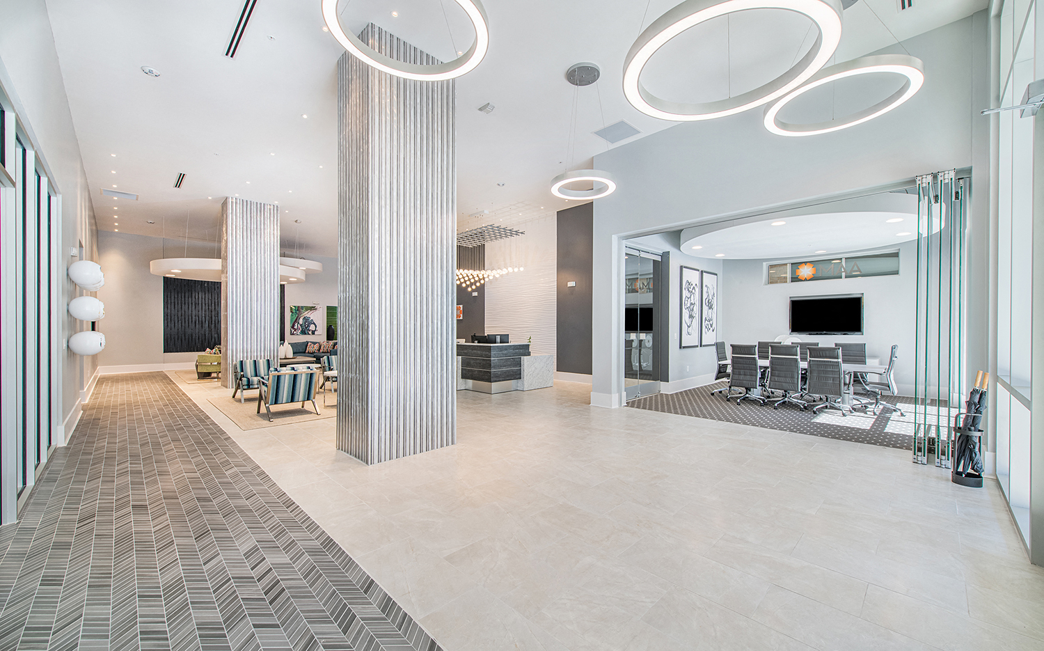 a large lobby with columns and chairs and a tv