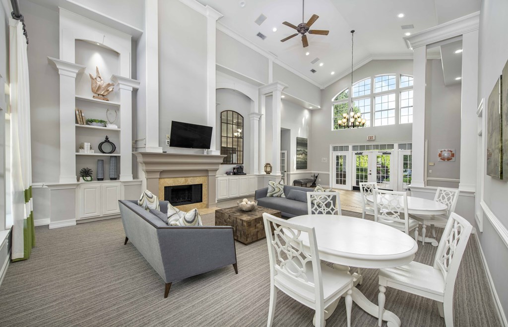 a living room with a table and chairs and a fireplace