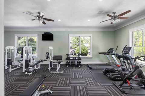 A spacious home gym with a variety of exercise equipment.
