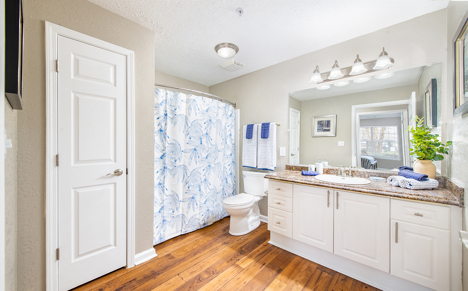 a bathroom with a shower and a sink and a toilet