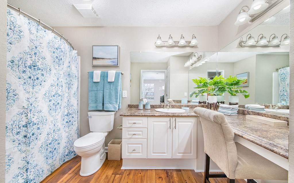 a bathroom with a shower and a sink and a toilet