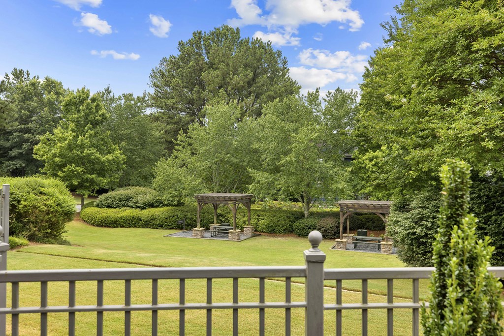 A backyard with a fence and a gazebo.