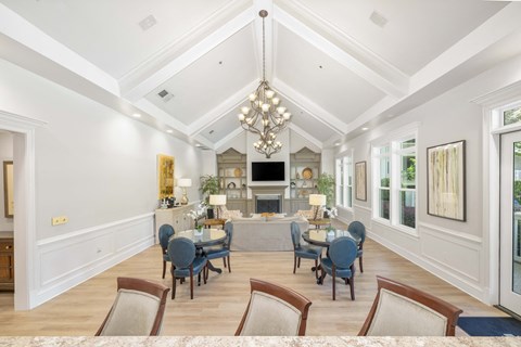 a dining room with a table and chairs and a living room