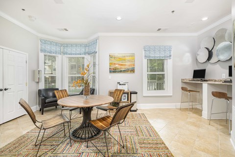 a living room with a table and chairs and a kitchen
