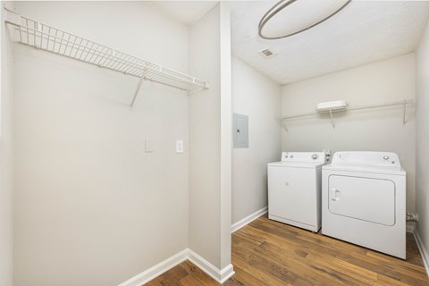 a room with a washer and dryer and a closet and a laundry room