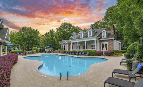 a large swimming pool in front of a house