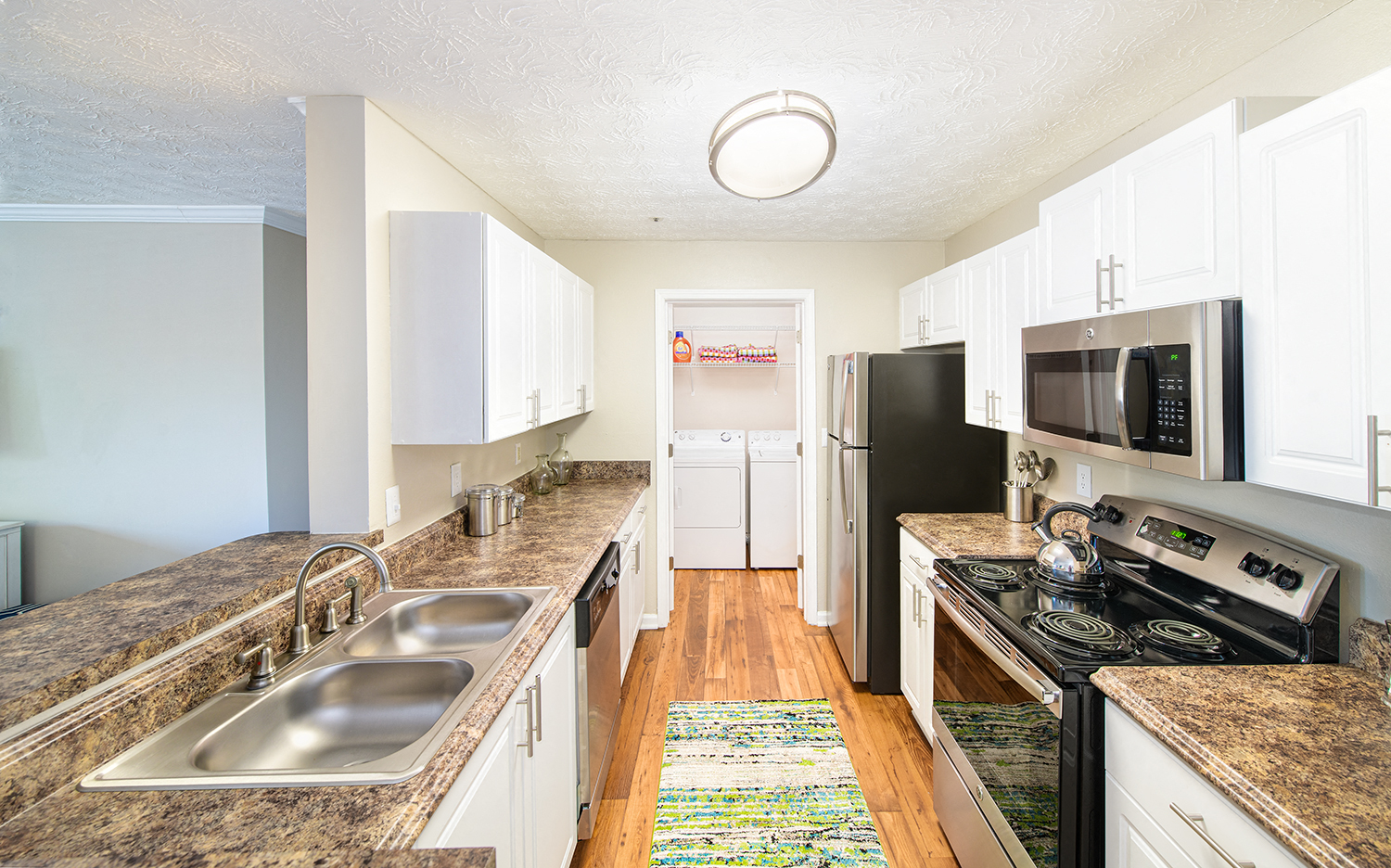 a kitchen with stainless steel appliances and marble counter tops
