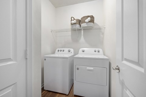 a washer and dryer in a small laundry room with a door