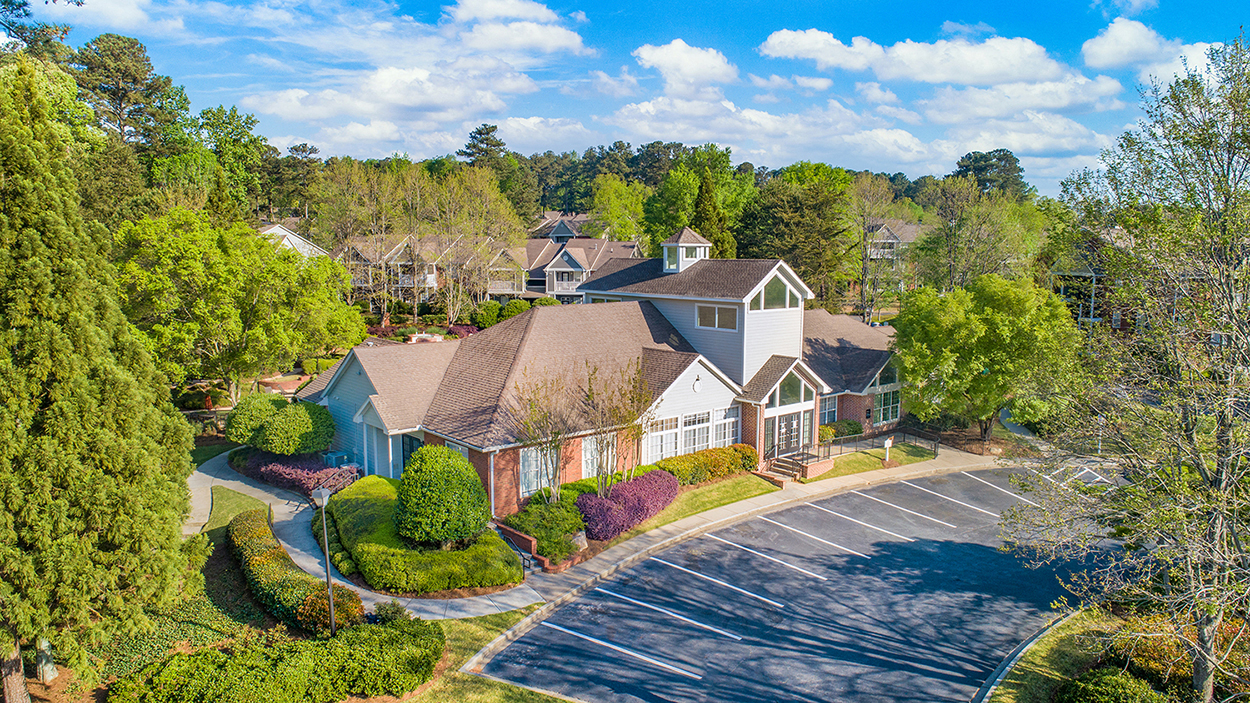 an aerial view of a neighborhood with houses and a parking lot