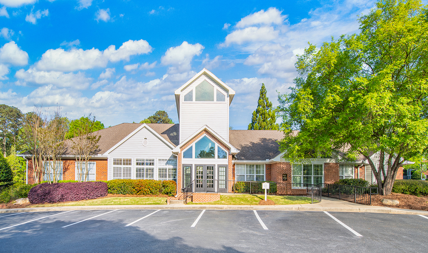 a large house with a parking lot in front of it