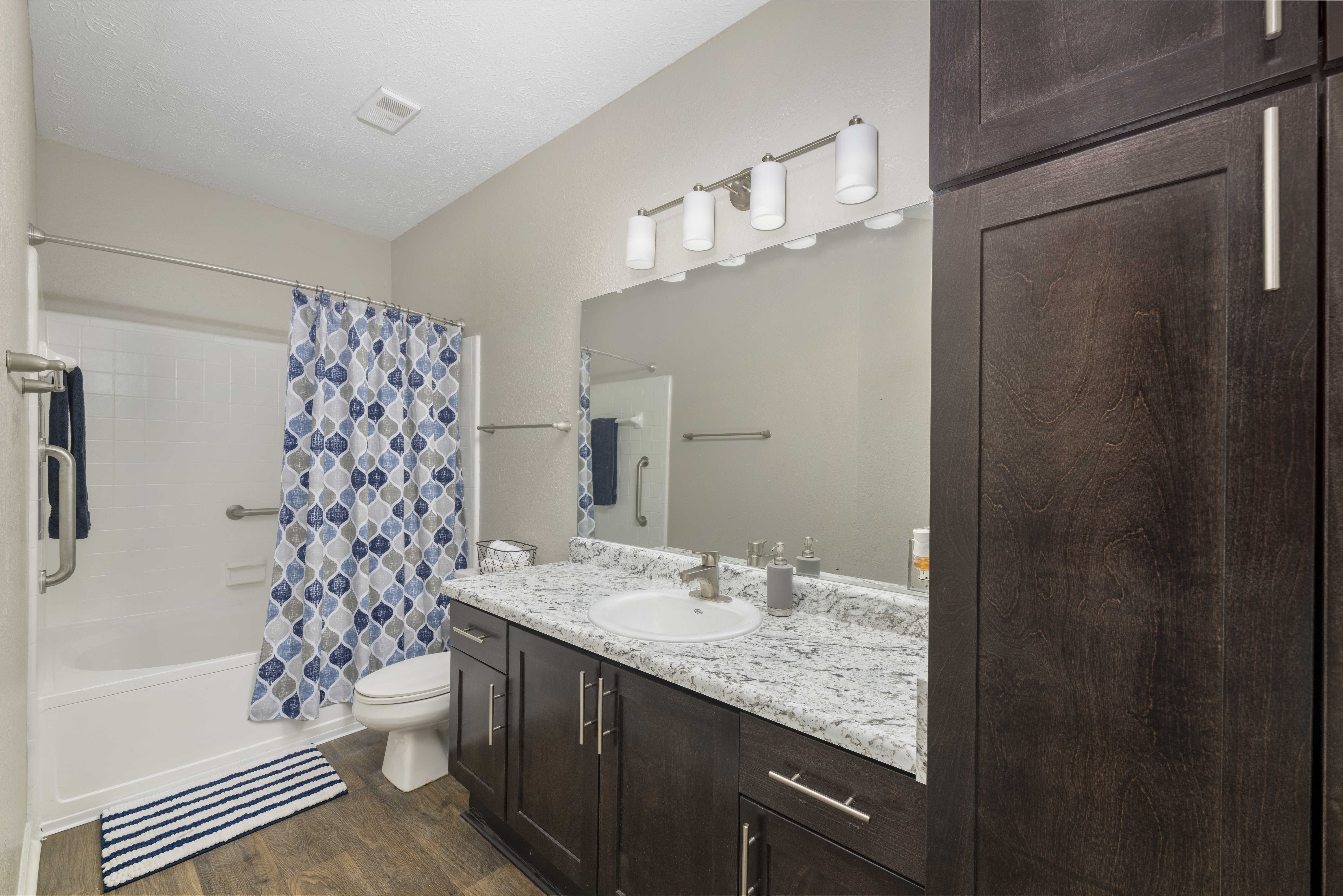 a bathroom with a sink and a shower and a toilet