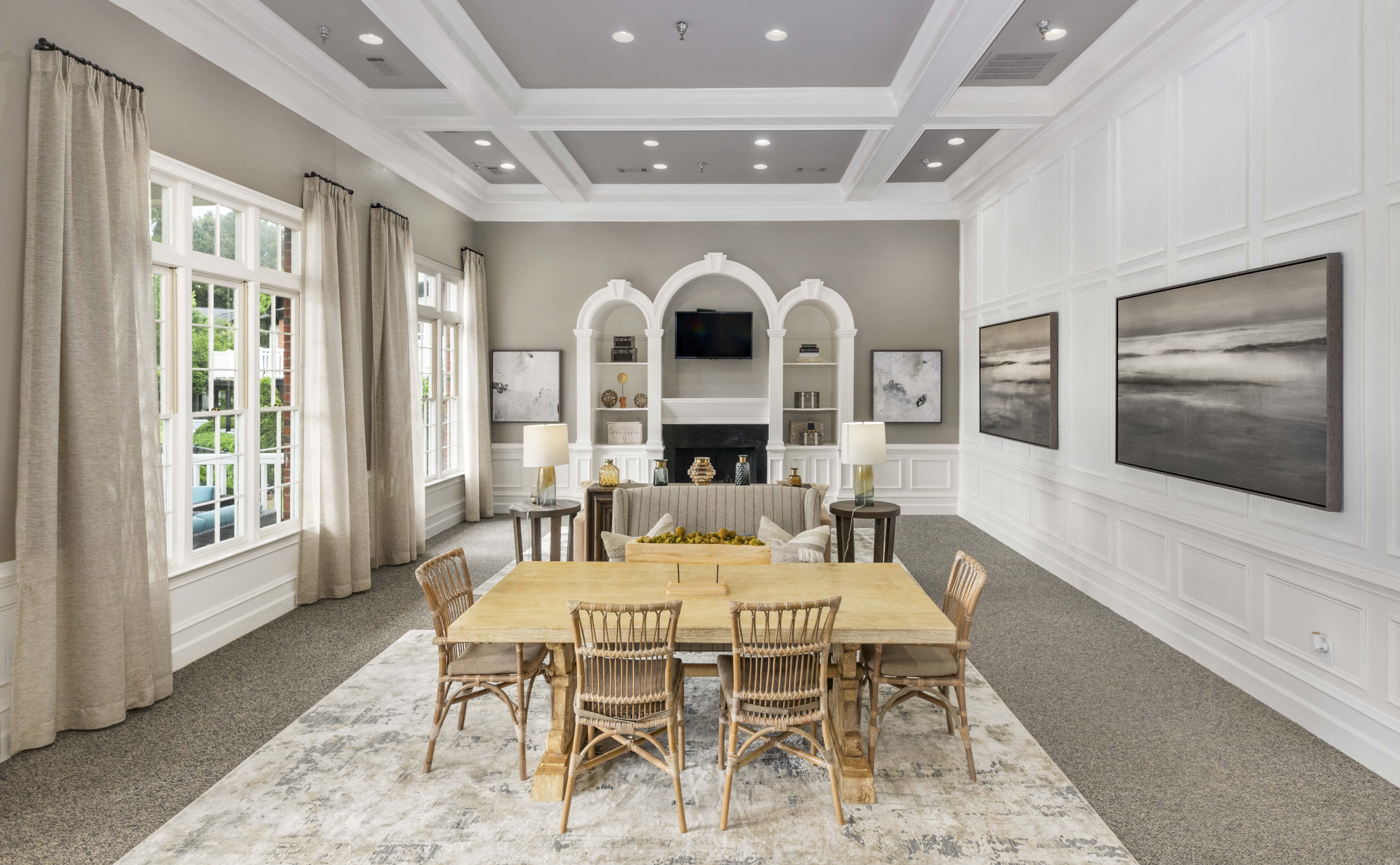 a dining room with a large table and chairs and a fireplace