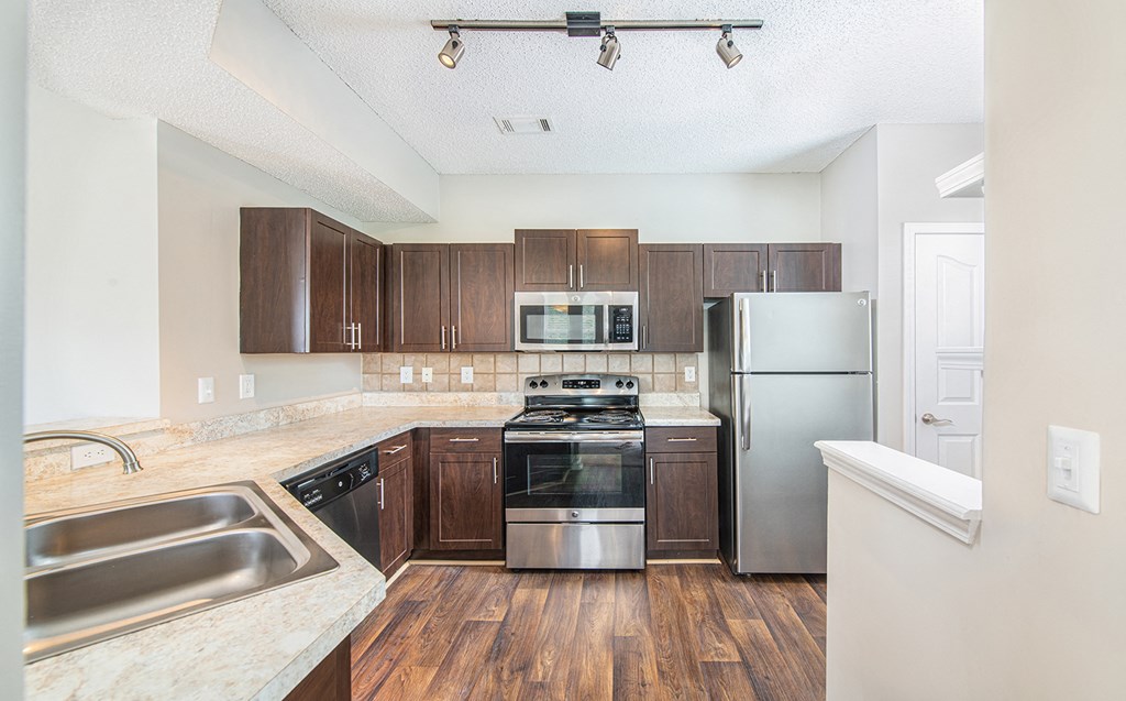 a kitchen with stainless steel appliances and wooden cabinets