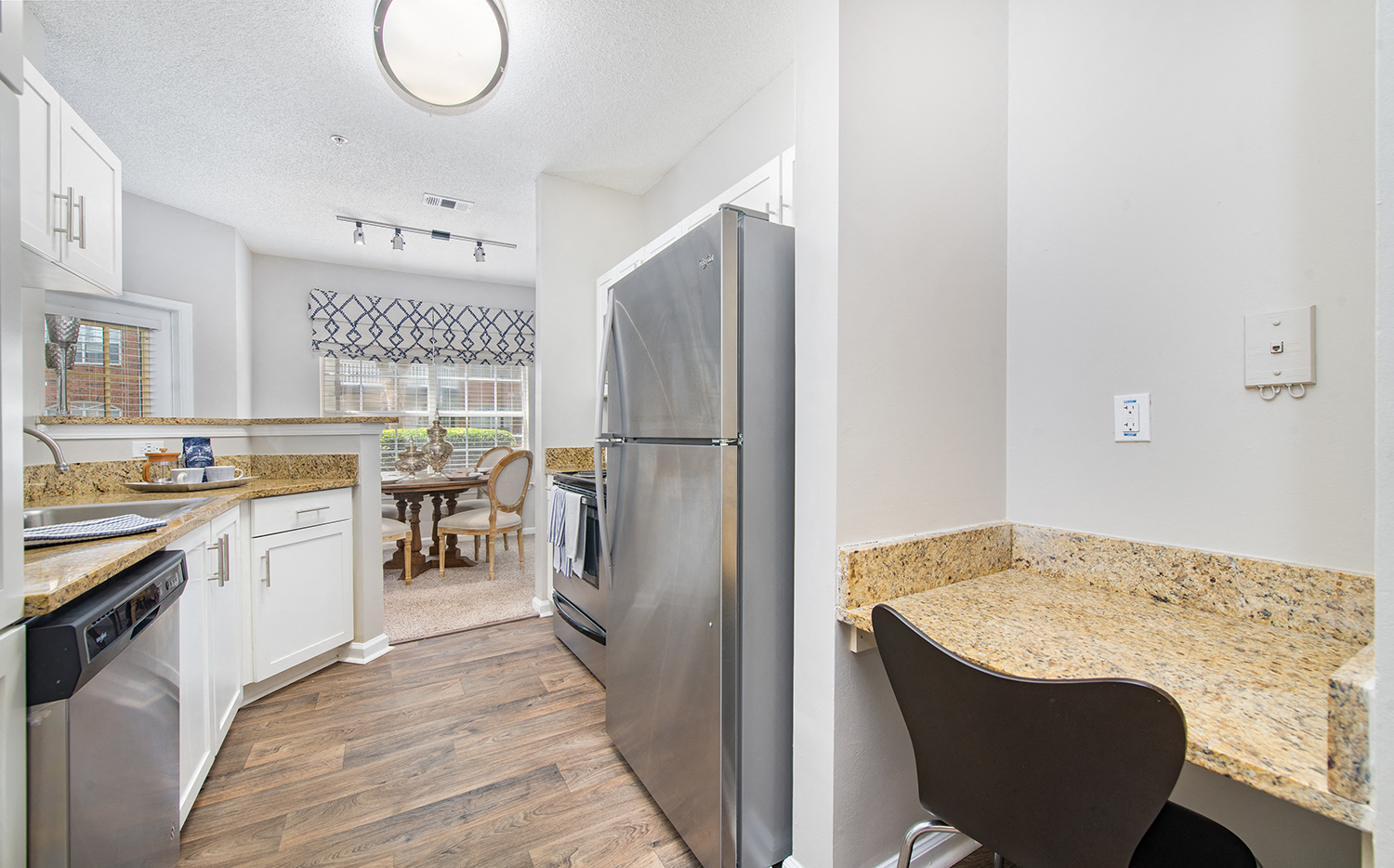 a kitchen with stainless steel appliances and granite counter tops
