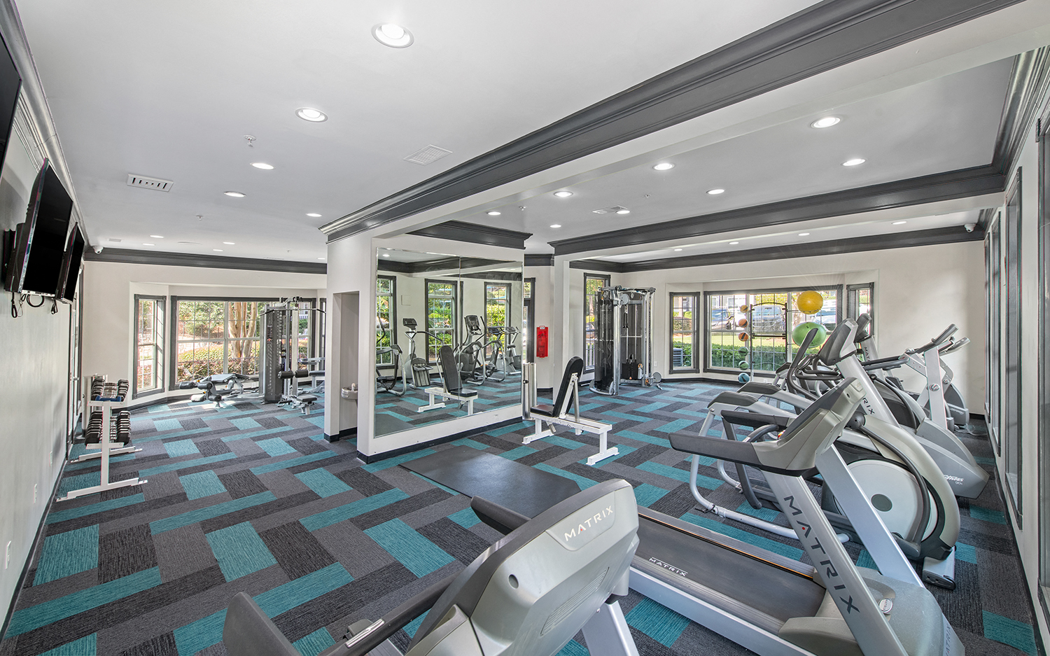 a gym with treadmills and other exercise equipment at the enclave at woodbury