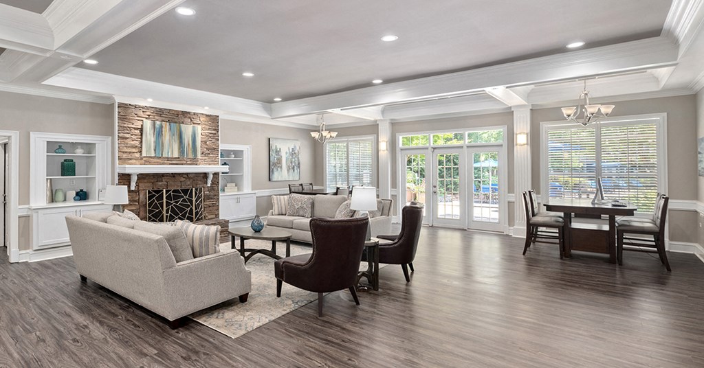 a living room with a fireplace and a table and chairs