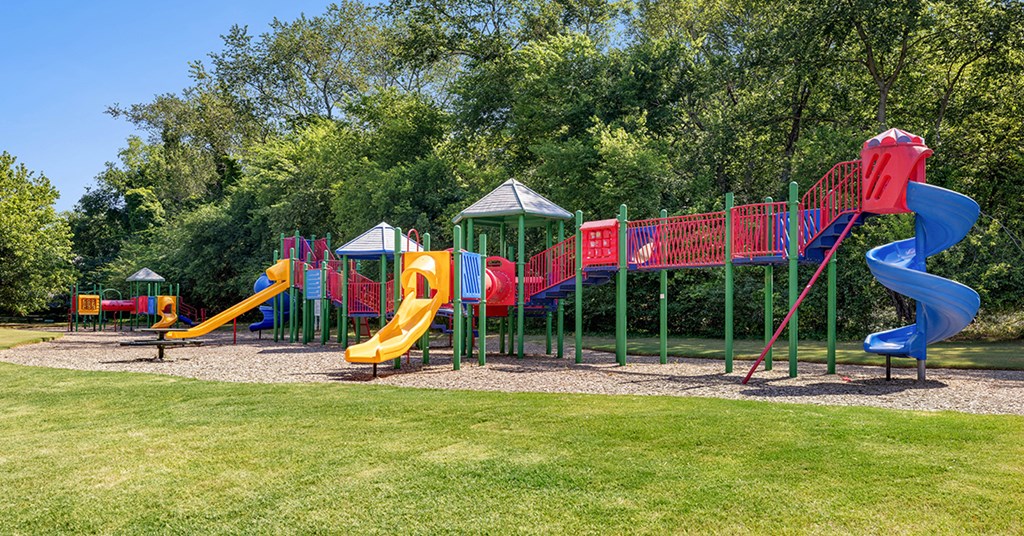 a playground with slides and other toys in a park
