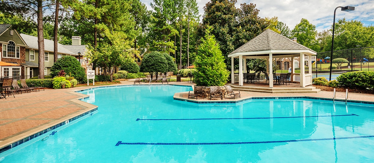 a swimming pool with a gazebo on the side of a resort pool
