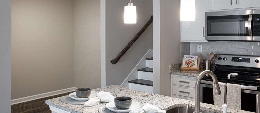 a kitchen with granite counter tops and a sink and a stove