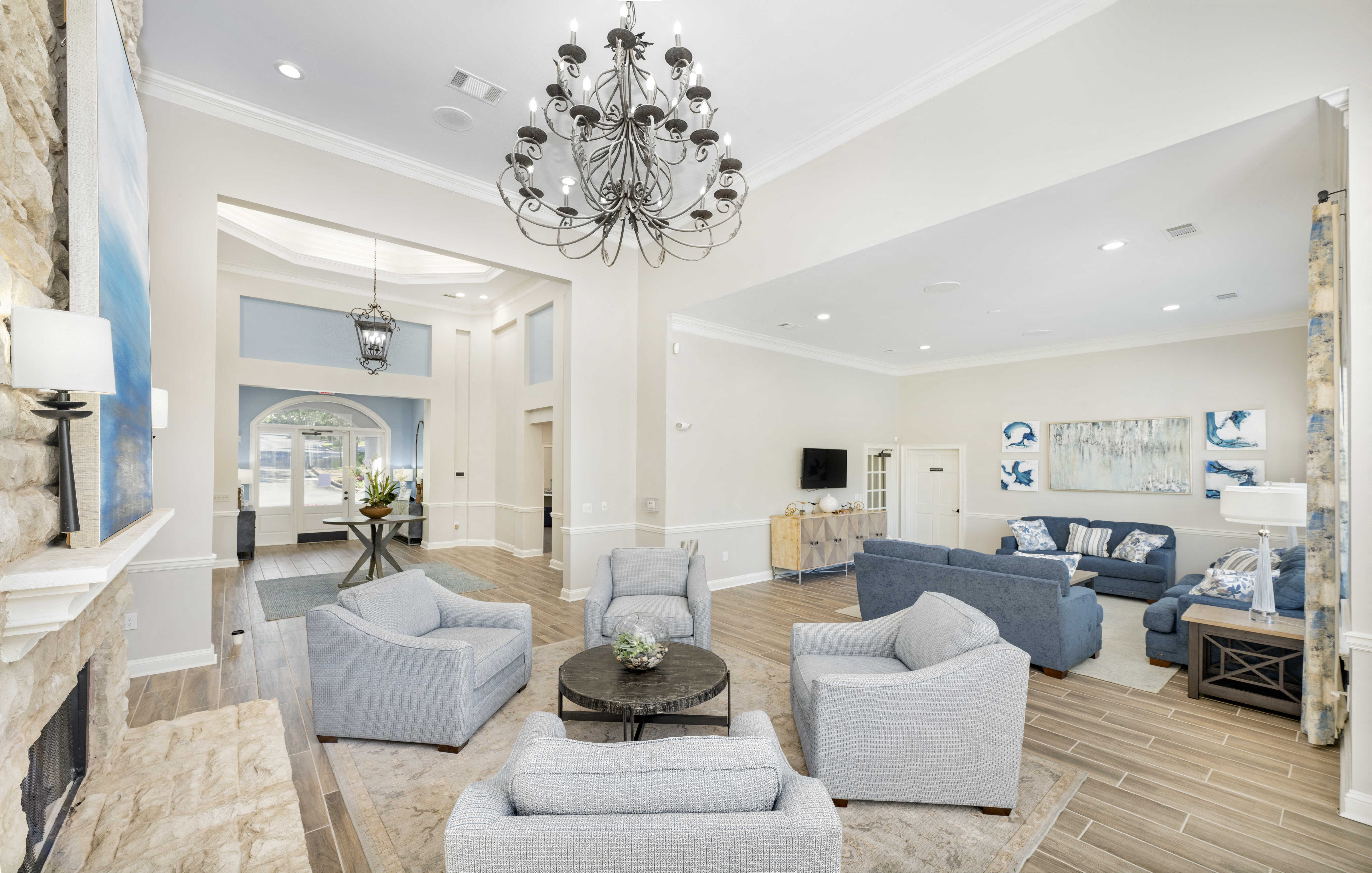 a living room with couches and chairs and a chandelier