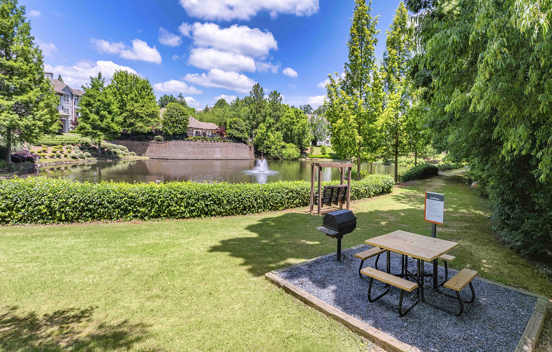 a park with a pond and a picnic table