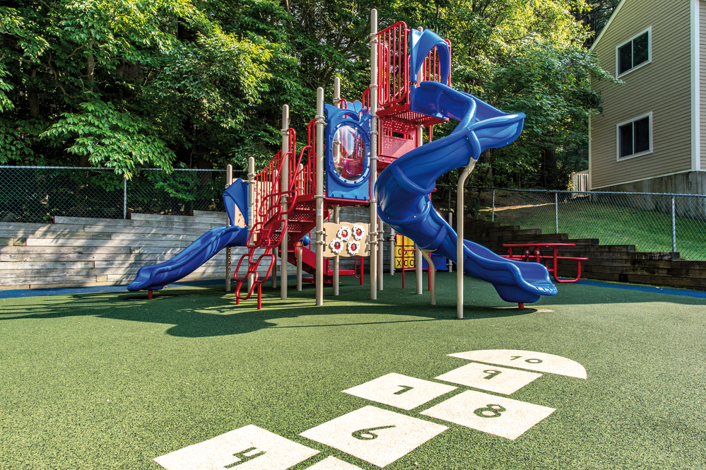 a playground with slides and other playground equipment in a backyard