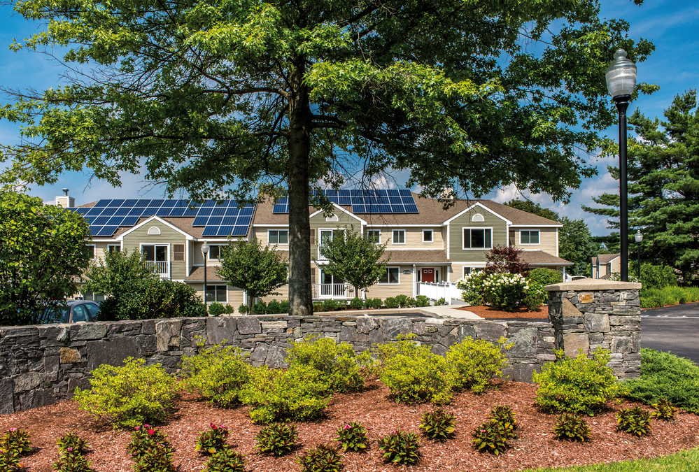 a large house with solar panels on the roof