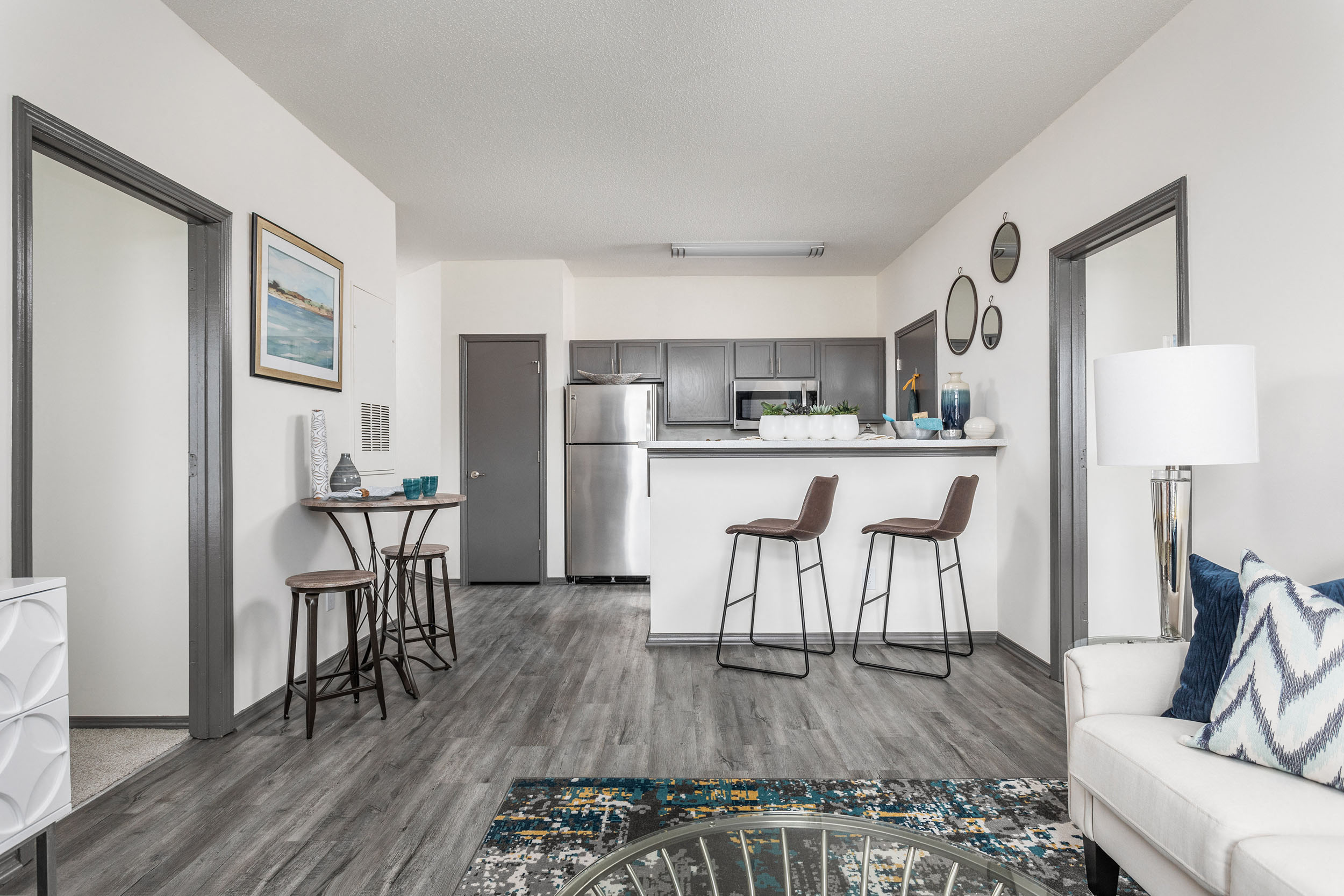 A modern kitchen with a dining table and chairs.