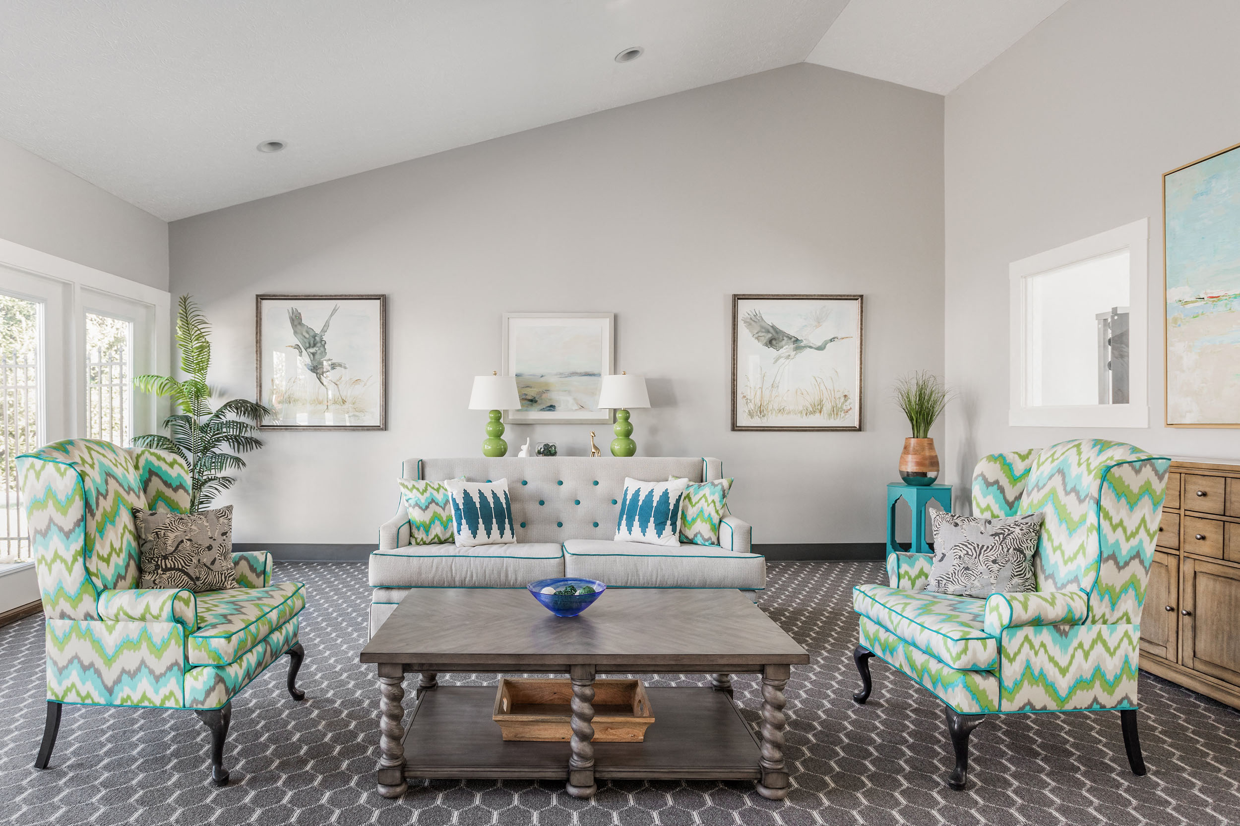A living room with a patterned sofa and matching armchair.