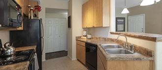 a kitchen with a sink and a stove and a refrigerator