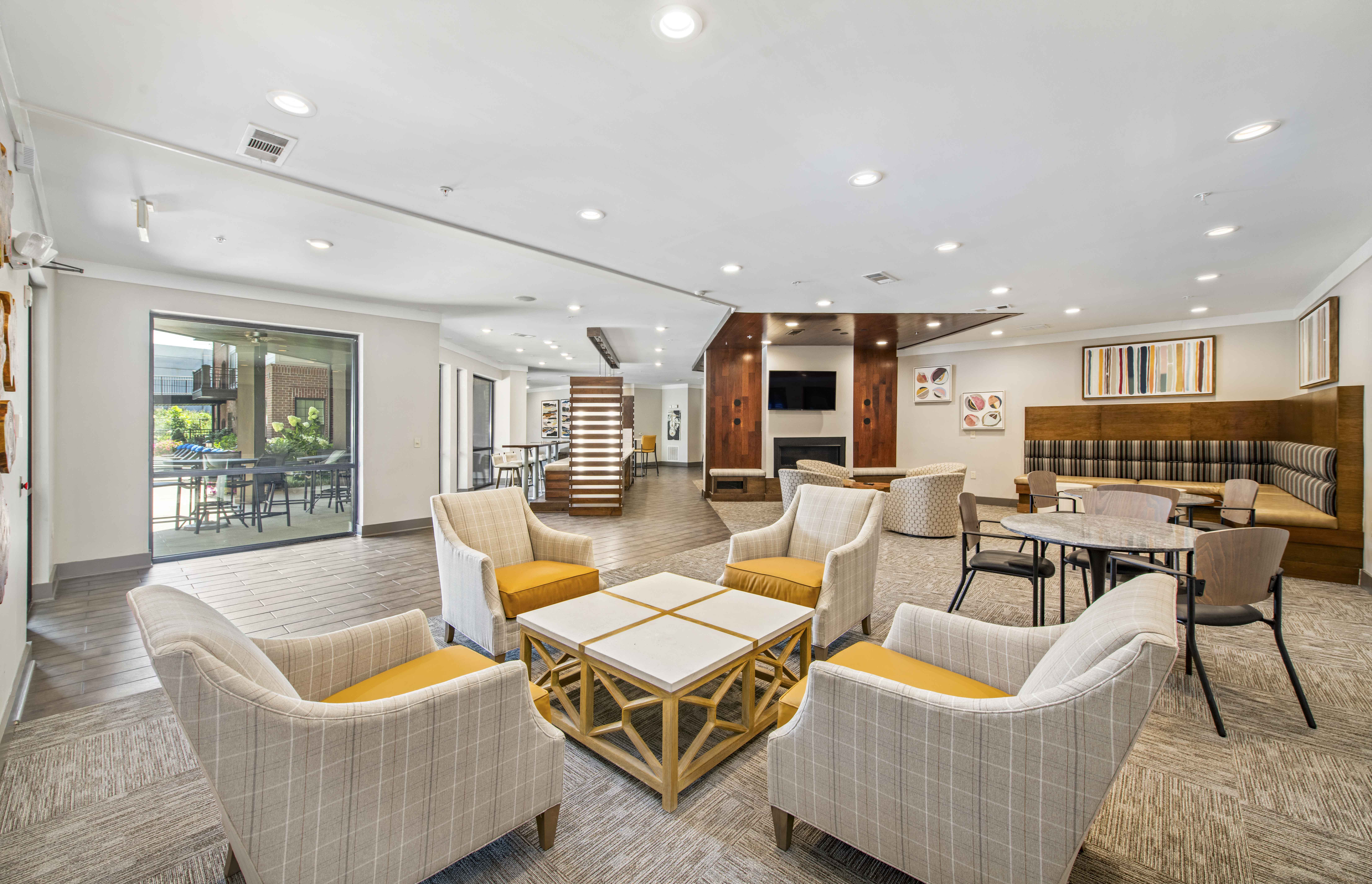 a living room with couches and chairs and tables