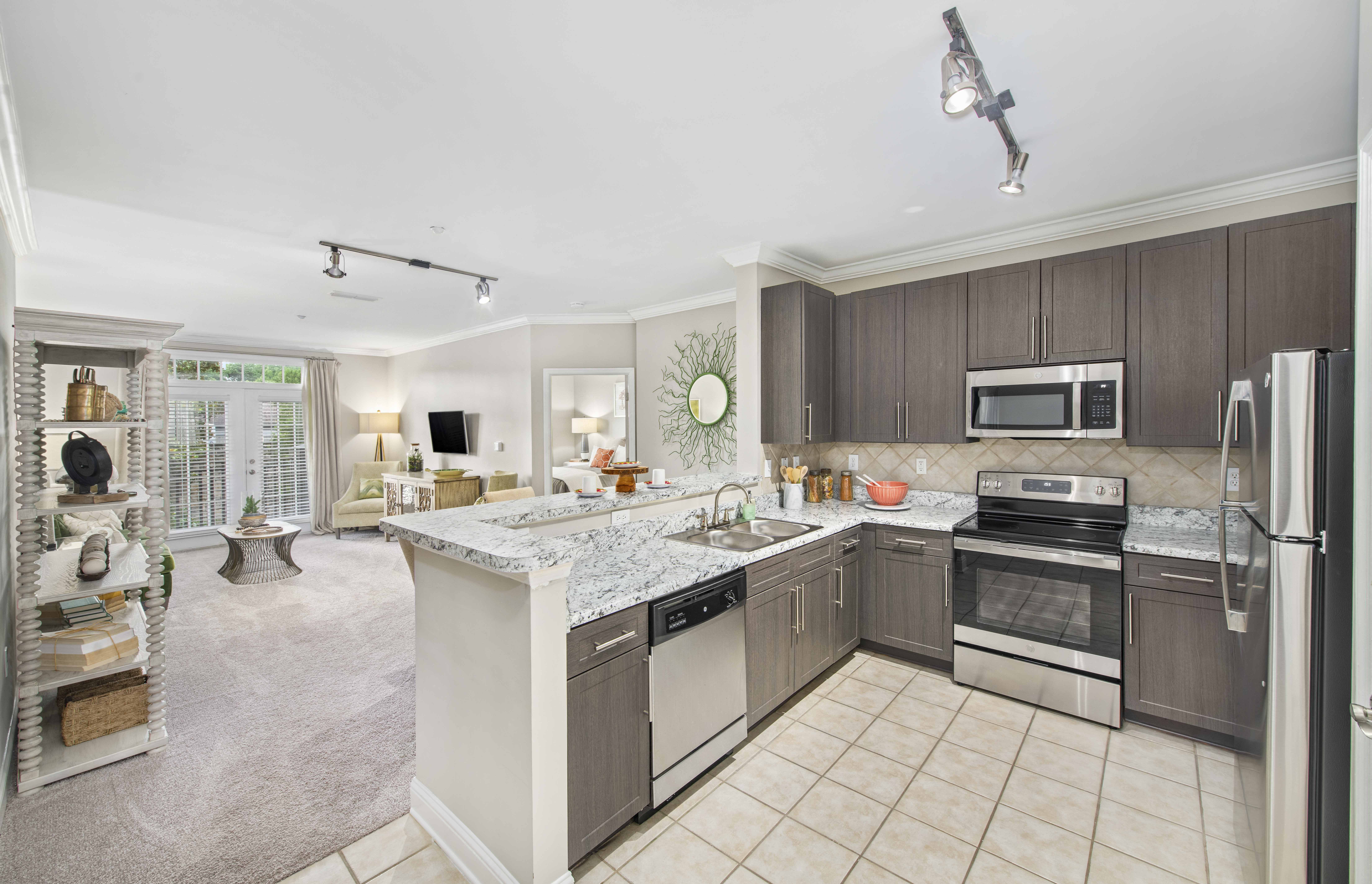 a kitchen with stainless steel appliances and marble counter tops