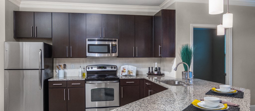 a kitchen with stainless steel appliances and granite counter tops